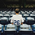 Child facing away from the baseball diamond in a stadium